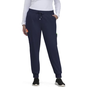 A pair of navy jogger pants with side pockets, elastic cuffs, and a drawstring waist, worn by a person.