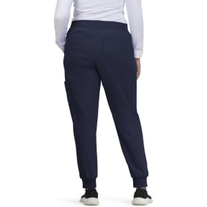 A pair of navy jogger pants featuring side pockets and elastic cuffs, worn by a person from the back.