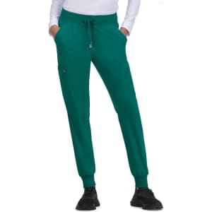 A pair of teal jogger pants featuring a drawstring waist and side pockets, worn with a white top and black shoes.