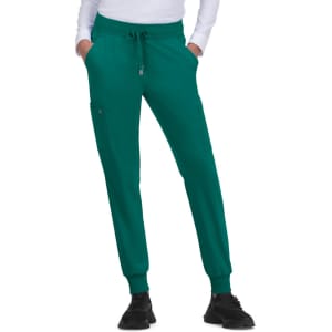 A pair of green jogger pants with an elastic waistband and side pockets, worn with a white long-sleeve top.