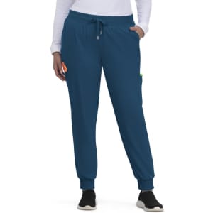 A pair of blue jogger pants featuring side pockets and an elastic waistband, worn by a person.