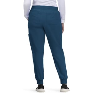 Blue jogger pants with a relaxed fit, featuring pockets and elastic cuffs, worn by a person from behind.