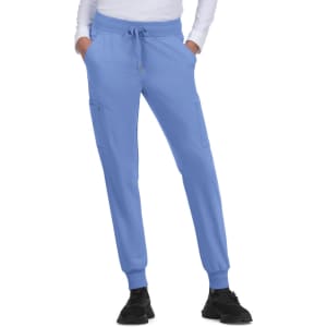 A pair of light blue jogger pants with pockets and a drawstring waistband, paired with black shoes.