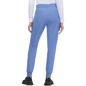 A pair of blue jogger pants with side pockets and elastic cuffs, worn by a person from the back.