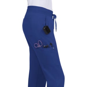 A pair of blue jogger pants with pockets, featuring scissors and other tools, designed for practical use.