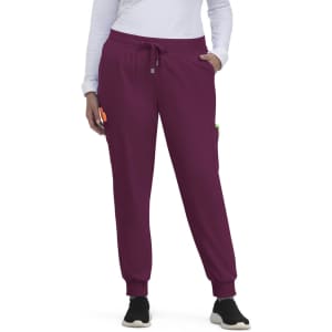 A pair of purple jogger pants with side pockets and a drawstring waist, featuring a logo.