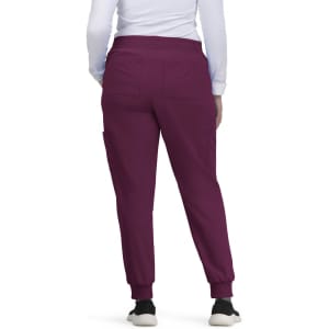 A pair of burgundy jogger pants with a tapered fit and elastic cuffs, featuring pockets on the sides.
