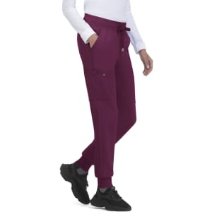 A pair of maroon jogger pants with pockets and a drawstring waist, paired with black shoes.