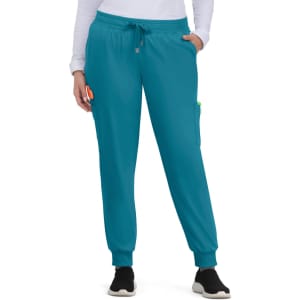 Turquoise jogger pants with a drawstring waist and side pockets, worn by a model.