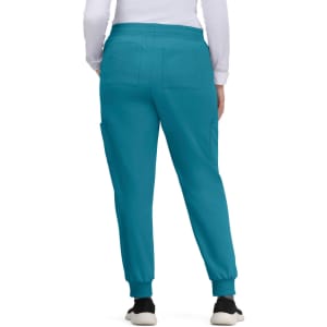 A pair of teal jogger pants with a tapered fit, featuring two back pockets and cuffed ankles.