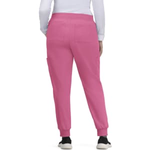 A pair of pink jogger pants with pockets, featuring a cuffed hem. The model is facing away, showing the back view.