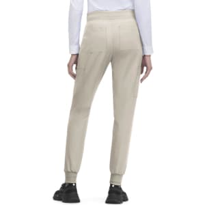 A pair of light beige jogger pants with side pockets, featuring elastic cuffs and a relaxed fit.