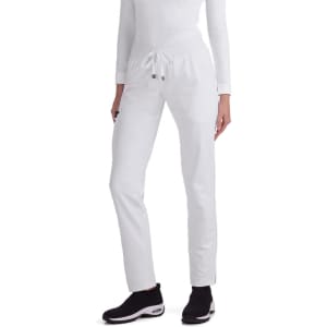White Atria Pant displayed on a model, featuring a drawstring waist and a sleek design, paired with black footwear.