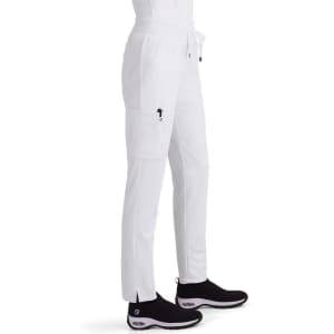 White cargo pants featuring side pockets and a drawstring waist, paired with black shoes. The image includes branding.