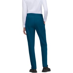Atria Pant in teal, featuring a smooth waistband and tapered legs, worn by a person from the back.