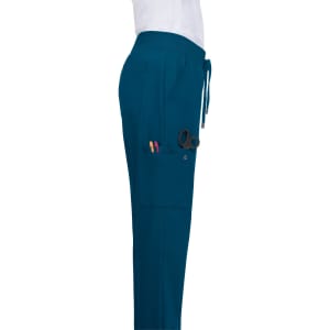 Atria Pant in teal with a side pocket holding scissors and pens. Features a drawstring waistband and logo.