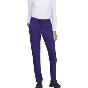 Atria Pant in purple featuring a drawstring waist and side pockets, displayed on a model wearing a white top.