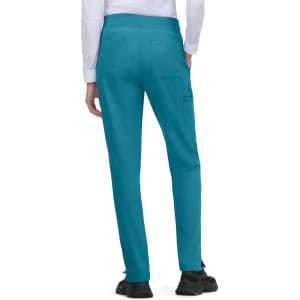 Atria Pant in teal, featuring a fitted design with back pockets. The model is shown from the back.