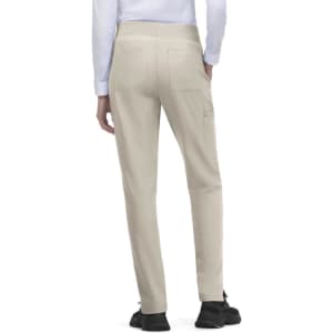 Atria Pant in beige, featuring a slim fit and pockets at the back. Includes a logo on the waistband.