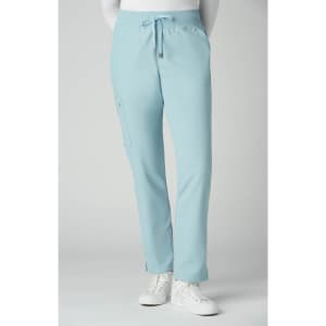 Atria Pant in light blue, featuring a drawstring waist and a side pocket. The model is wearing white shoes.
