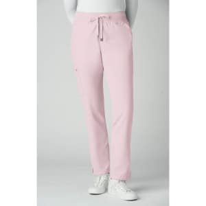 Atria Pant in soft pink, featuring a drawstring and side pocket, modelled by a person wearing white sneakers.