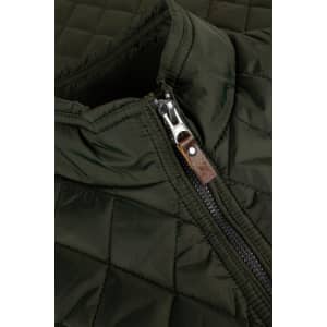 A quilted green vest featuring a zip closure and a leather accent on the zipper.