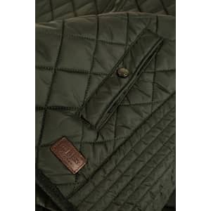 A quilted green vest featuring a logo patch, with button and snap closures on the front.
