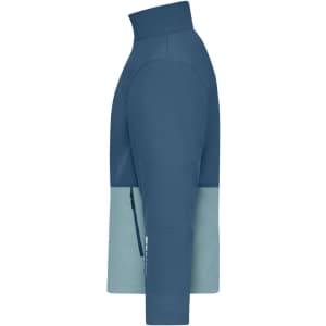 A softshell jacket in blue and light blue, featuring a high collar and a side zip pocket. It has a logo.