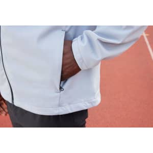 A grey men's softshell jacket with a zip pocket, featuring a close-up of the cuff and side.