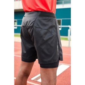 Men's running shorts in black, featuring a logo and a lightweight design, viewed from the back on a track surface.