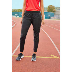 Black ladies' running pants with an elastic waistband, styled for athletic wear, set against a running track background.