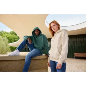 A khaki oversized hoody on a person and a green oversized hoody on another person, both in an outdoor setting.