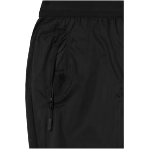 A close-up of black men's running pants featuring a zippered pocket and an elastic waistband.
