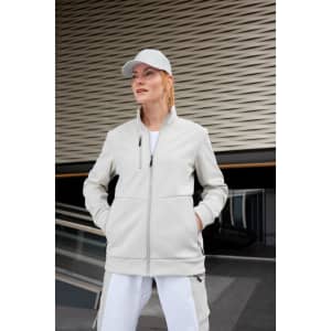 A light grey fleece jacket with a zip front, featuring a collar and pockets, worn by a model outdoors with a cap.