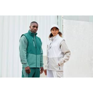 A green and grey softshell vest worn by two models, featuring a zippered front and a logo.