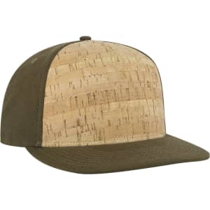 A snapback cap featuring a cork front panel and an olive green visor. It includes a logo on the side.