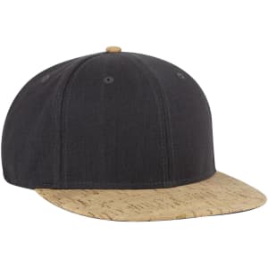 A snapback cap featuring a black fabric body and a cork-patterned brim. It includes a logo on the front.