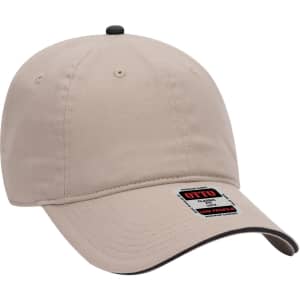 A beige 6 panel low profile baseball cap with a black accent and a logo on the side.