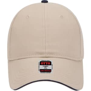 A beige low profile baseball cap featuring a branded label and contrasting navy details on the peak.
