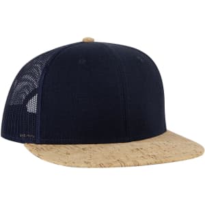 A dark navy trucker cap with a cork brim and mesh back, featuring a logo on the front.