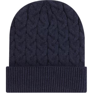 A navy blue cable knit beanie with a rib knit cuff and a distinctive logo.