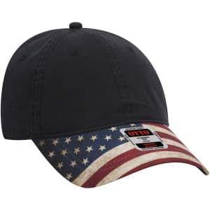 A black low profile baseball cap with a flag-patterned brim and a brand logo.