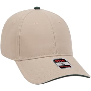 A beige low profile baseball cap with a green peak and a logo on the side.
