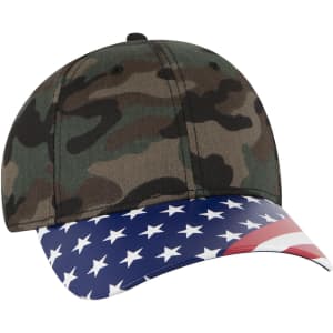 A camouflage baseball cap with a low profile style and an American flag design on the brim. It features a logo.
