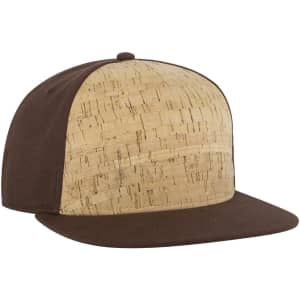 A 5-panel snapback cap featuring a cork front panel and brown fabric sides and brim. Includes a logo.