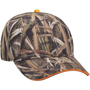 A camouflaged baseball cap in shades of brown and green with an orange accent and a logo on the side.