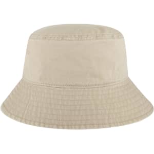 A beige bucket hat with a wide brim, featuring a textured pattern and a small logo.