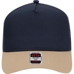 A 5 panel mid profile trucker cap in navy blue with a beige brim and a logo on the front.