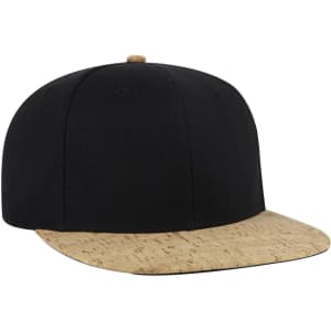 A mid-profile snapback cap featuring a black crown and a cork-coloured brim. It has a logo on the front.