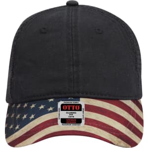 A black low profile trucker cap with an American flag design on the brim and a logo tag on the front.